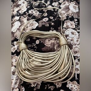 Boutique gold metallic "noodle" knotted woven clutch/crossbody